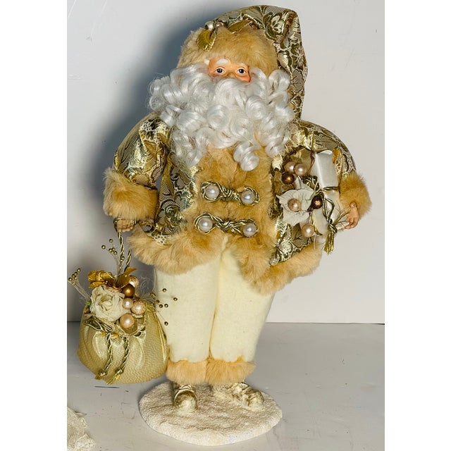 Vintage Santa Claus richly decorated in white velvet and gold brocade coat, both trimmed with faux fur. Holds a gold bag...