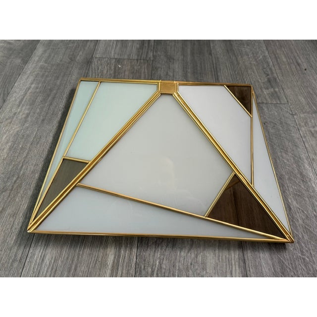 Pyramid-shaped ceiling or wall lamp with white opal glass and gold-colored metal. Square base with one light source. Made...