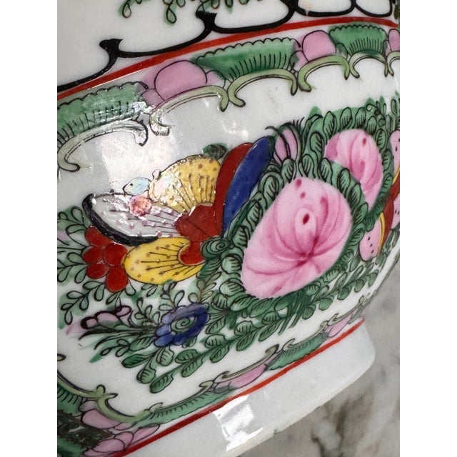 Presenting a vintage famille rose large decorative bowl in classic pinks, greens, celadon, yellow and gold gilt. Featuring...