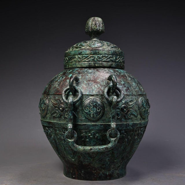 This stunning vessel is masterfully crafted from heavy solid bronze with a rich, mottled green and brown patina. It...