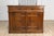 An Italian walnut buffet from the 17th century with drop front section, hidden drawers, two doors and carved dentil...