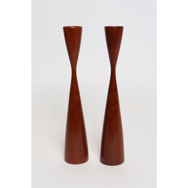Pair of sculptural, organic teak candlesticks designed by Flemming Digsmed's eponymous design/manufacturing company,...