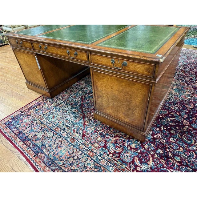This Large 72 Inch English George II Style Burl Walnut Leather Top Partners Desk features an antique brass handle finish...