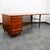This clean Stow and Davis executive desk in walnut offers a wraparound top, fitted with a pull-out slide, two short walnut...