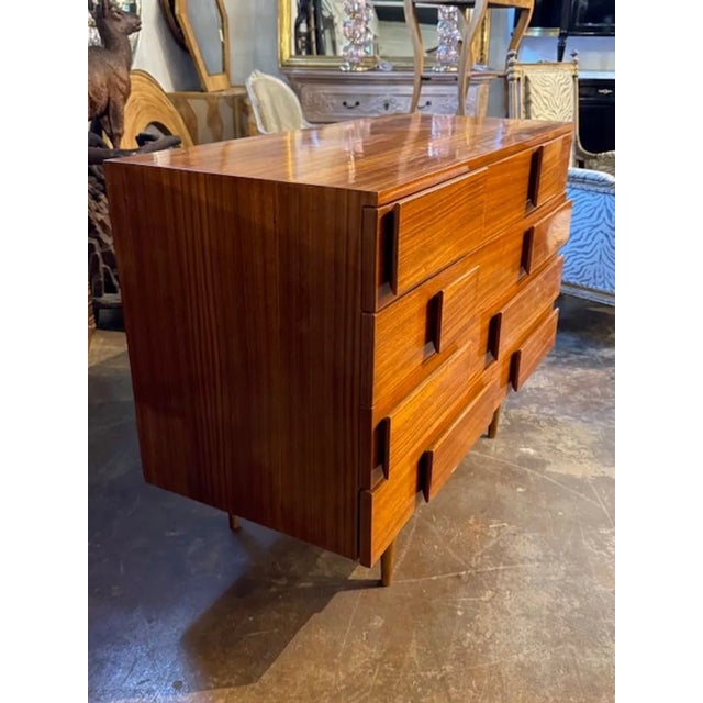 The Modern Italian Gio Ponti Manner Walnut Chest is a stylish and elegant piece of furniture. The chest features...