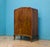 Compact walnut linen cabinet with a drawer over double doors. Inside are fixed shelves for practical storage. The drawer...