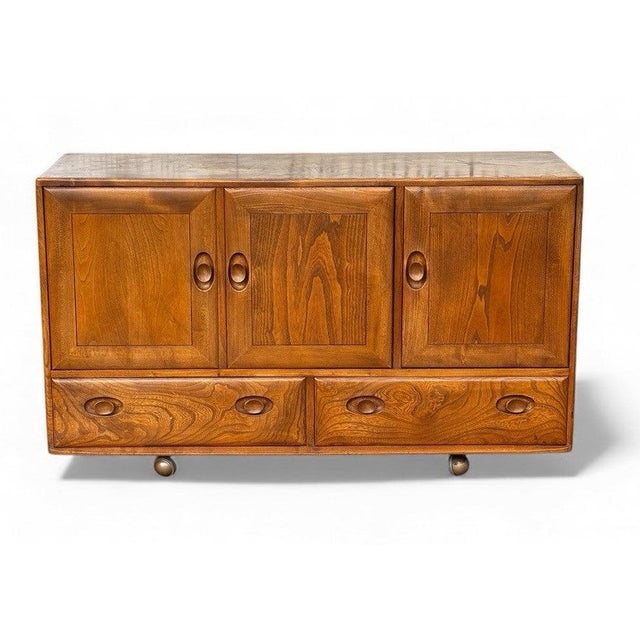 Mid Century Ercol Sideboard Sizes :- 76 cms tall, 130 cms wide, 44 cms depth. It’s an old used item, although in good...