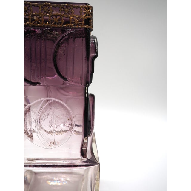 Purple glass vase nordic design from Kumela Oy. With circular shapes on all sides of the vase and a patterned brass band,...