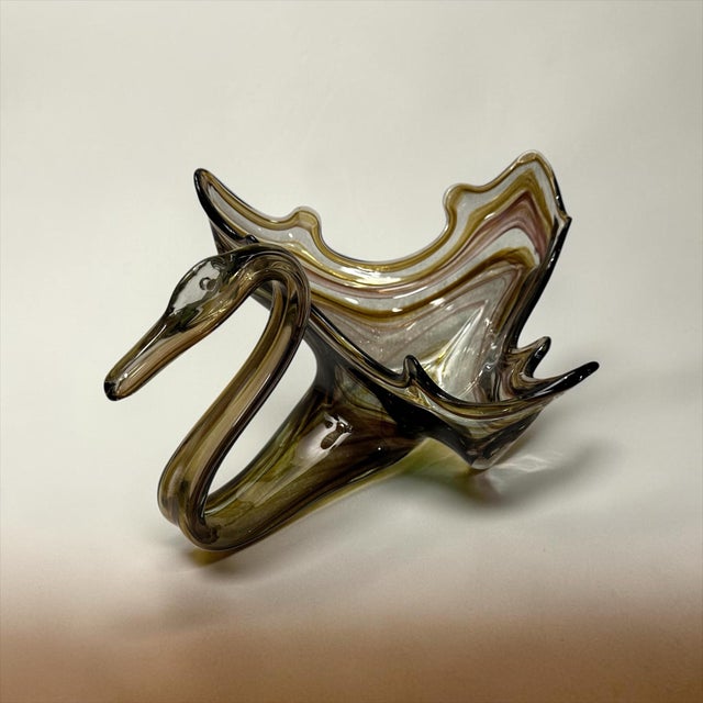 Crafted in the iconic Murano style, this gorgeous console dish features a gracefully sculpted swan neck and a dramatic,...