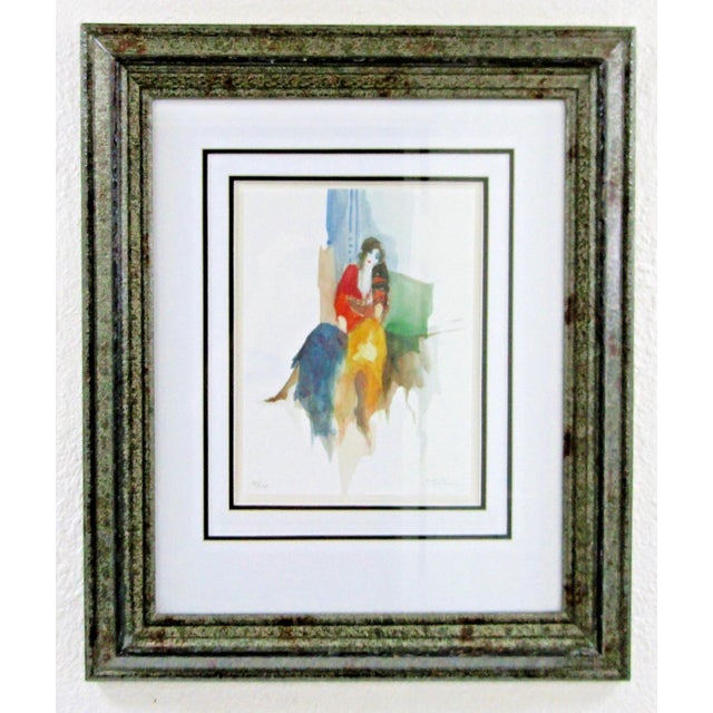 This is a signed and numbered lithograph by artist Itzchak Tarkay depicting a seated Bohemian woman. This medium-sized...