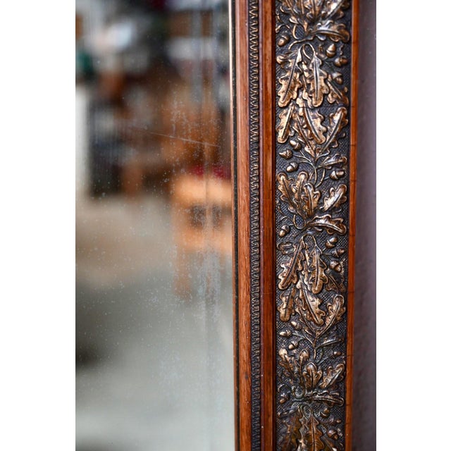 Here is a lovely mirror with bohemian flair. Its wood and stucco frame features a repeating motif of embossed oak leaves...