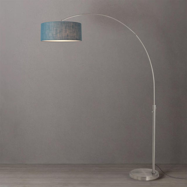 Featuring a sweeping, gracefully arched silhouette, the Float Arc Lamp is a modern masterpiece designed by Peter Morelli...