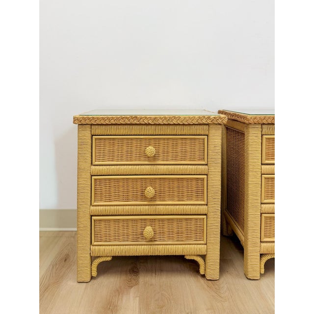 This charming pair of vintage Henry Link wicker 3-drawer nightstands are a warm and practical coastal and Hollywood...