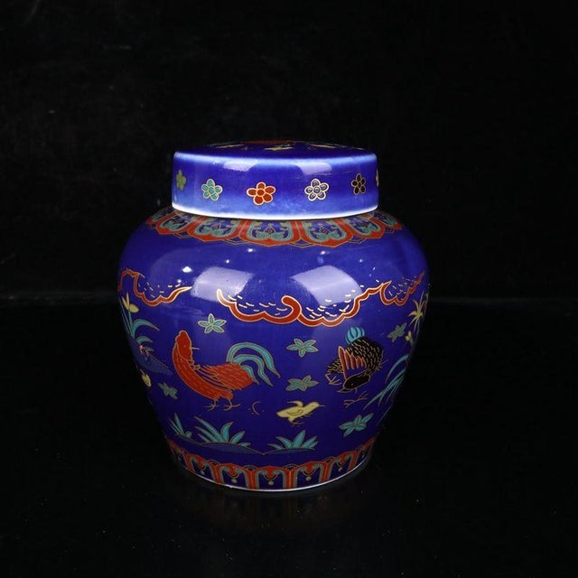 Compact Chinese porcelain ginger jar with a striking deep blue ground, finished with colorful doucai enamel and delicate...