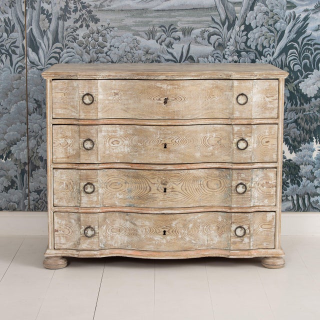 A Danish chest of drawers from the early 19th century in original, natural pine with traces of original paint. Shaped top...