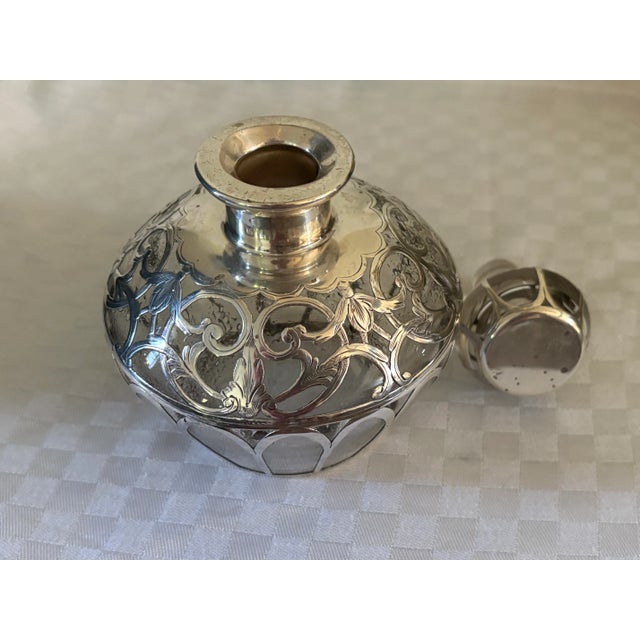 Large sterling silver overlay perfume or cologne bottle with a unique design in etched silver. The art nouveau piece...