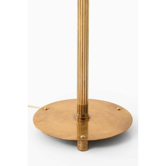This rare height-adjustable floor lamp, produced in Denmark by an unknown designer, is a finely crafted example of mid-...