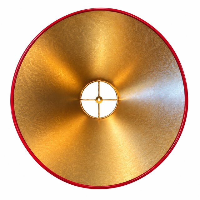 This custom hand-lacquered lampshade features a high-gloss hardback exterior and a gold ponyhair-lined interior that casts...