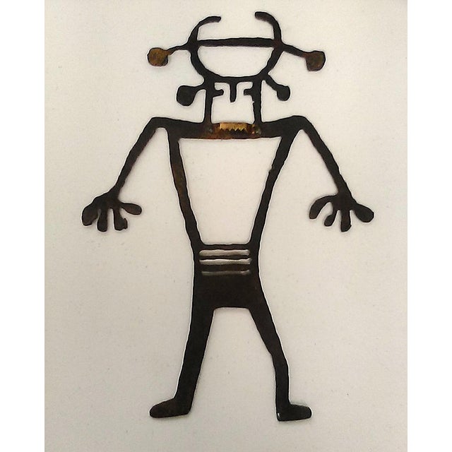 Unique laser cut metal figurine depicting a Petroglyph Rock Art Silhouette of the Sun Head Man or Sun Face Spirit. The...