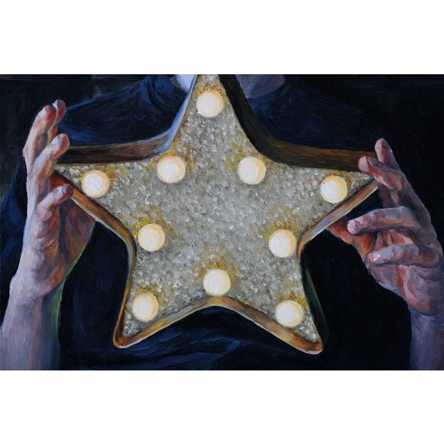 The artwork features a figure holding a luminous star, its surface sparkling with light bulbs that create a warm glow...