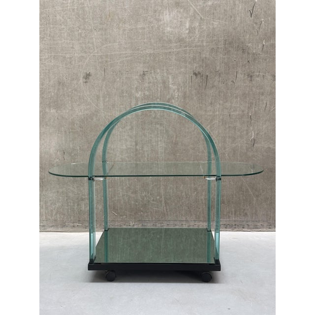 Meet this exceptionally elegant 1980s postmodern bar cart, masterfully crafted by the renowned fiam in italy. This...