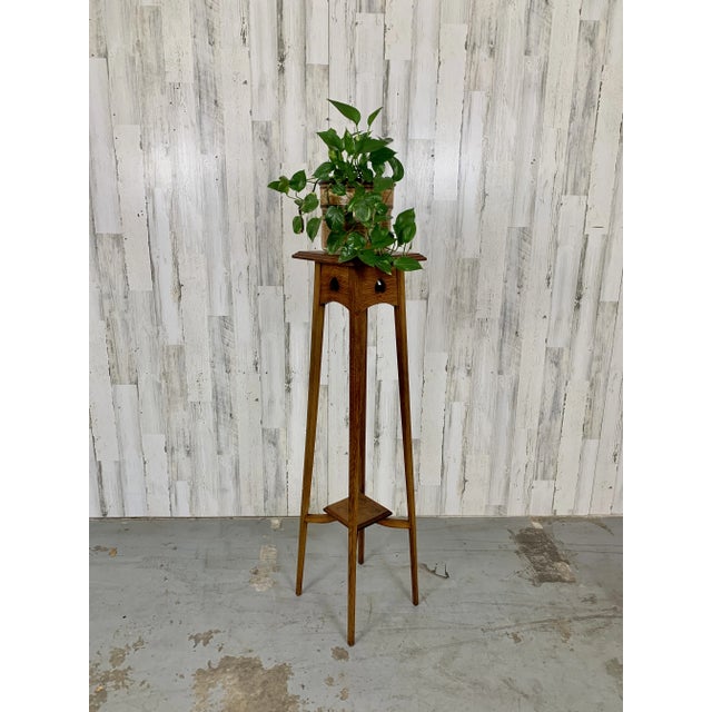 Very tall candle / plant stand made of solid quarter sawn oak with spade shaped design on the apron of the top.