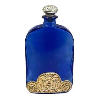 Vintage Cobalt Blue Spanish Art Glass Flask With Ornate Embossed Scrollwork Medallion For Sale