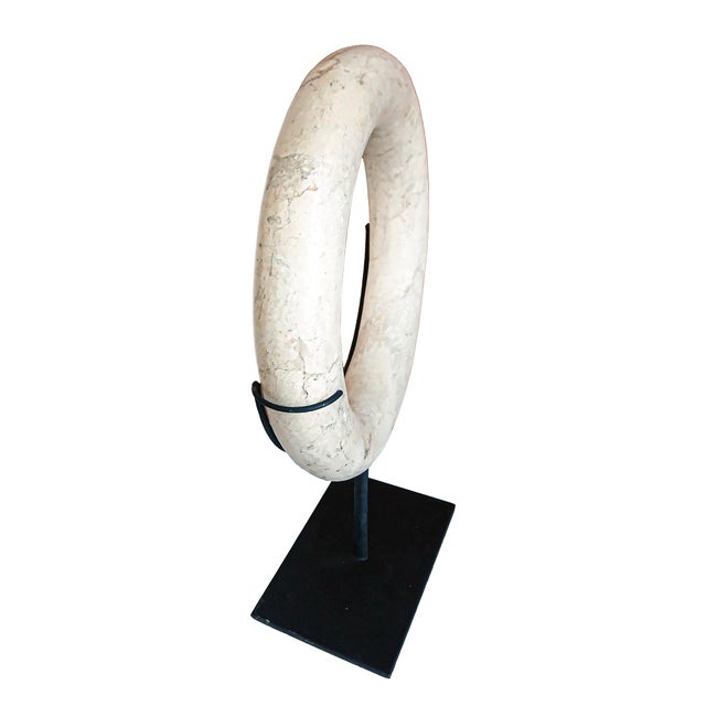 A hand-carved Indonesian marble ring / hoop on stand, contemporary. 10" Diameter, 14" High (mounted). Stand base: 7" W x 4" D