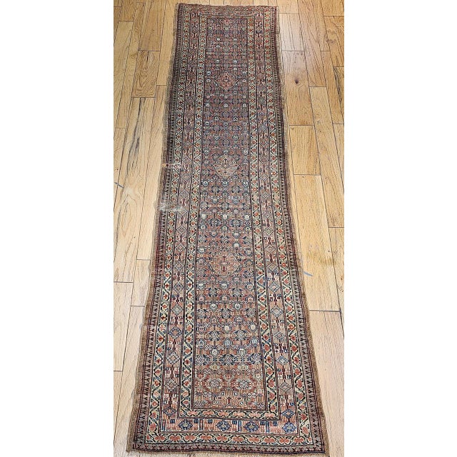 "An exceptional late 19th century Persian Serab camelhair runner featuring an allover geometric pattern, handwoven in the...