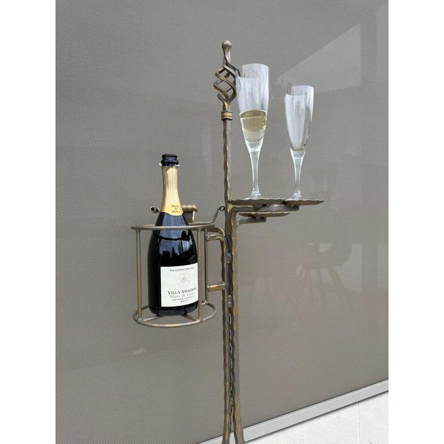 Hand-forged wrought iron bar and smoking stand with sculptural twisted finial and hammered detailing. Executed in a dark...