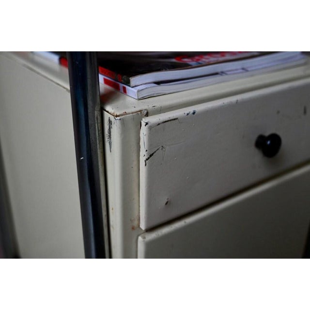 with its distinctly industrial look, this 1950s boarding school bedside table has a strong personality! Featuring tubular...