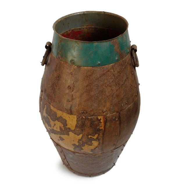 Vintage solid iron pot from India. Traditional patch work form with rivet details and iron ring handles. Originally used...