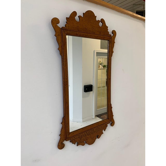 An antique Chippendale style bird’s-eye maple fret-carved wall mounted mirror in a warm honey tone with a rectangular...