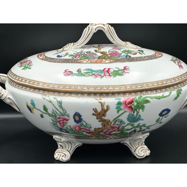 A striking hand painted Indiana Tree–style porcelain tureen featuring richly detailed florals, a central tree vignette,...