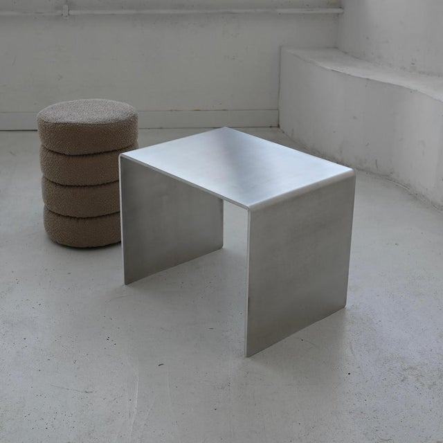 Minimalist Sculptural Accent Table in Aluminum by Veliento. Dimensions: W 40 x D 30 x H 35 cm. Materials: 10mm thick...