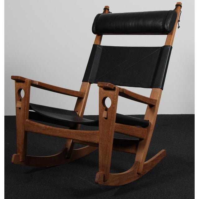 Hans J. Wegner lounge chair / rocking chair original black leather upholstery. Frame of soap treated oak Model...