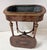 A napoleon iii marquetry jardinière in veneered wood. it rests on four tapered, fluted feet with brass rings. the...