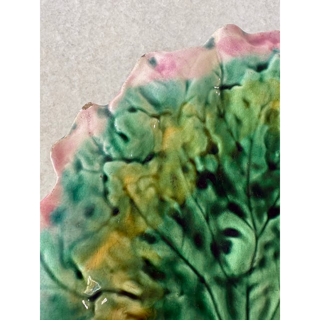 19th-century Etruscan Majolica leaf dish was crafted by Griffen, Smith & Hill and features vibrant green, yellow, and pink...
