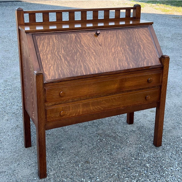 The desk is built from fumed quarter-sawn oak wood, commonly referred to as "tiger oak" due to the golden ray figures in...