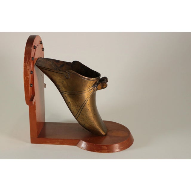 These antique brass gaucho stirrups are mounted on expertly-crafted dovetailed wooden bookends. Each features a hand-...