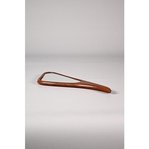 Danish hand mirror made of teak wood. A very elegant piece in a typical mid century shape. The mirror has a few minor...