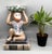 Delightful ceramic monkey seated with raised arms supporting a green-and-white bok choy–style bowl overhead, a design also...