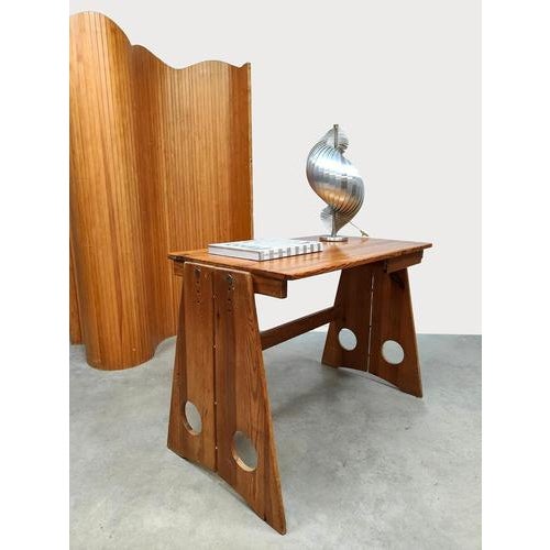 This Brutalist vintage wooden desk is a unique Scandinavian design, created by Gilbert Marklund. What makes this desk...