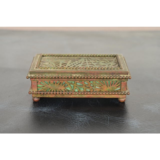 A gorgeous antique Arts & Crafts or Art Deco period bronze and Favrile slag glass "Pine Needle" pattern desk box, stamp...
