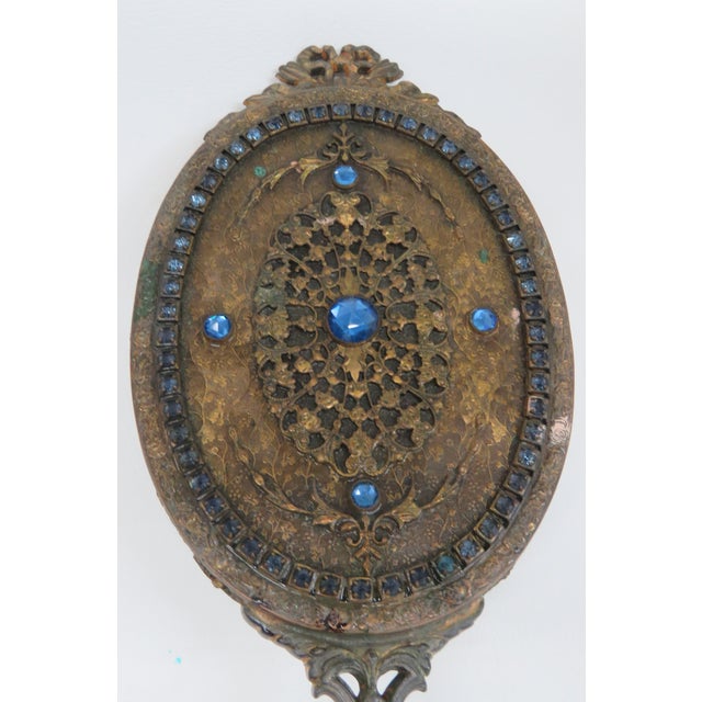 This exquisite hand mirror is made out of brass and mirrored glass. This Hand Mirror has an incredible Empire style; it...