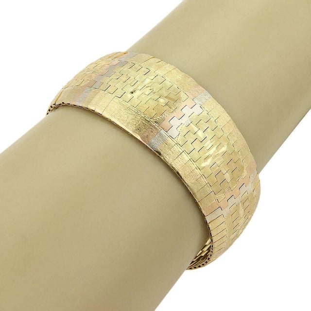 This bold and beautiful estate bracelet is crafted from 18k yellow, white and rose gold with a high polished finish. The...