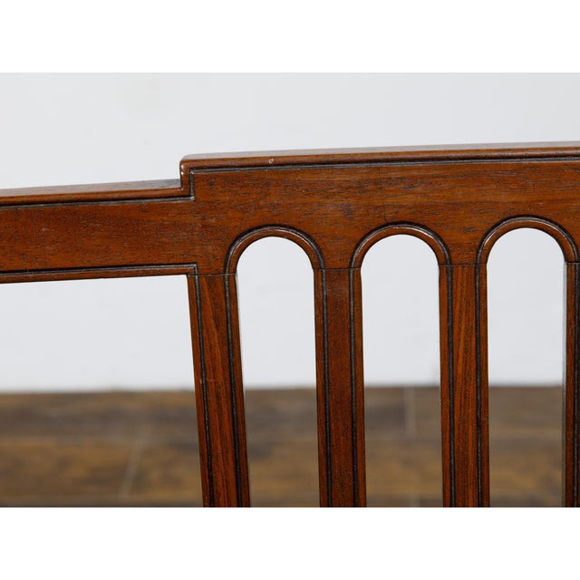 A pair of English George III period plank seat chairs from circa 1800 with pierced backs, slightly scrolling arms,...