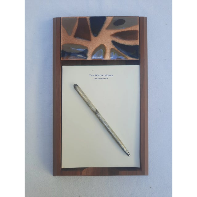 This is a vintage Mid-Century Modern hand-carved walnut wood desktop notepad tray embellished with enamelized melted glass...