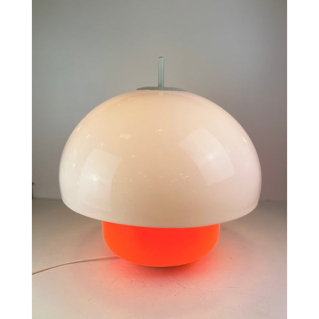 Large Italian table lamp made of an orange glass base with a white acrylic lampshade on top. Each of them can be lit...