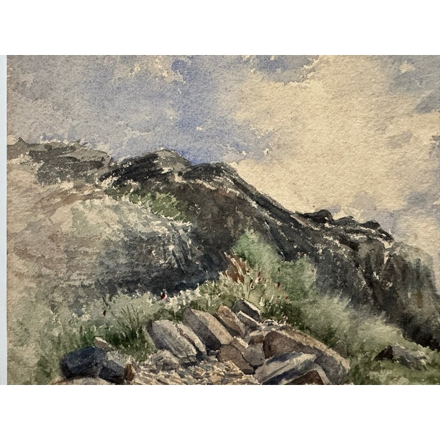 Original watercolor on paper depicting a rugged, rocky mountain landscape with a boulder-strewn path or dry streambed,...